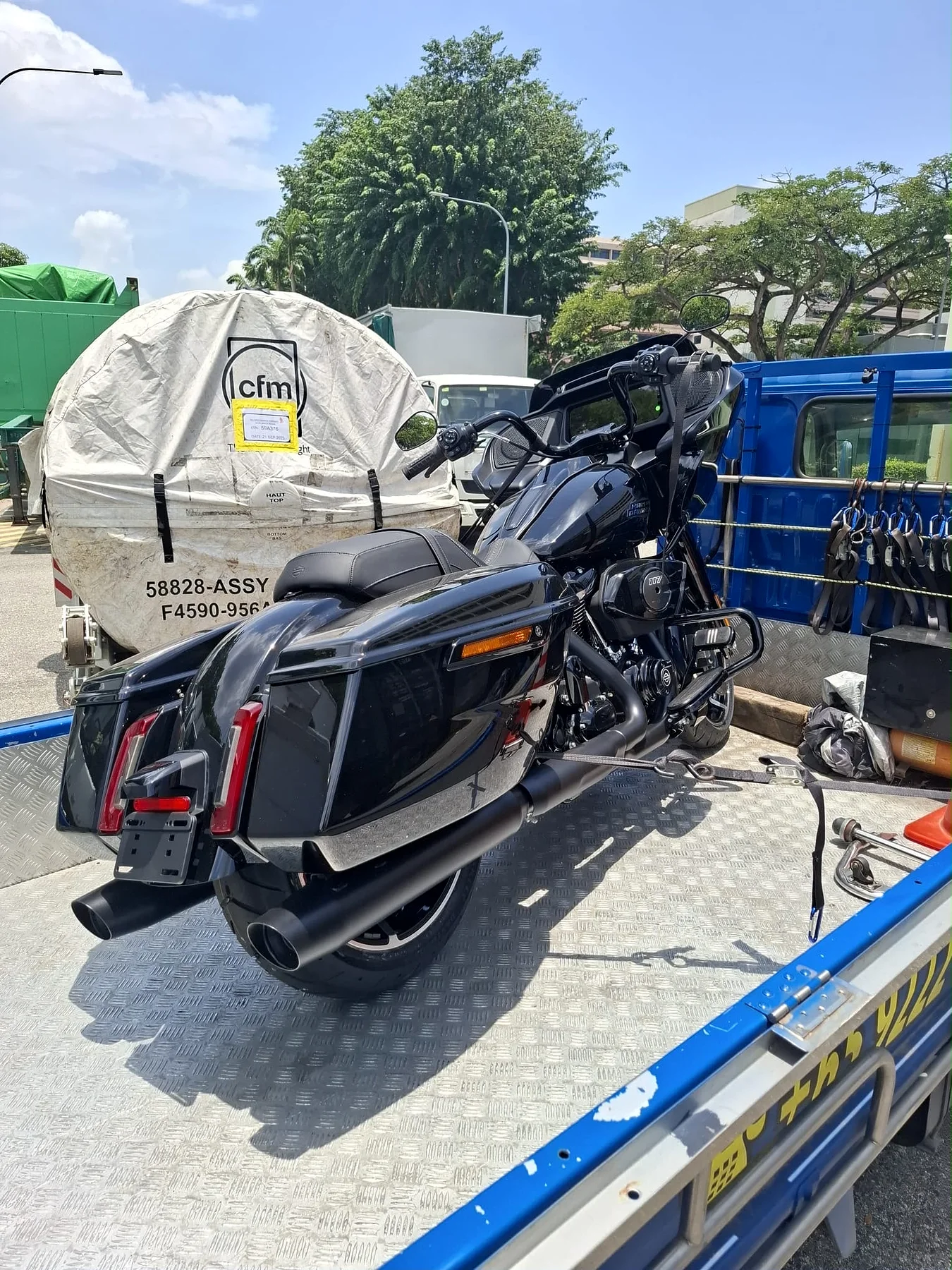 Large scooter being prepared for motorcycle towing in Singapore